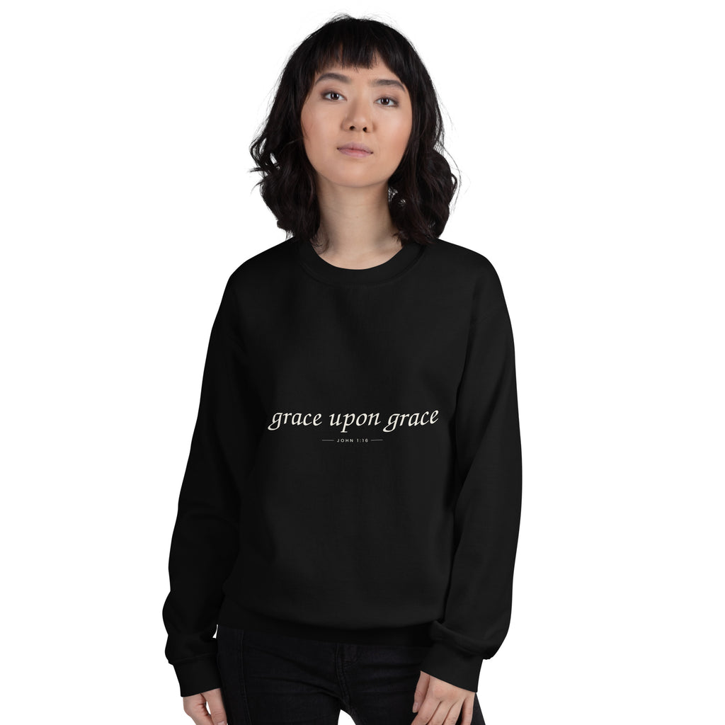 Grace Upon Grace Christian unisex crewneck sweatshirt in Black, front view on women's model