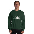Held. Christian unisex crewneck sweatshirt in Forest Green, front view on model
