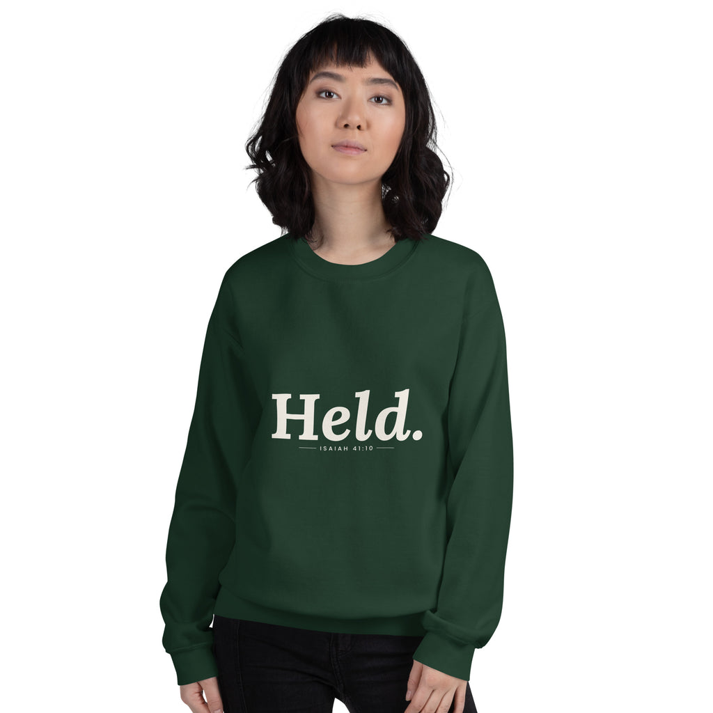 Held. Christian unisex crewneck sweatshirt in Forest Green, front view on women's model