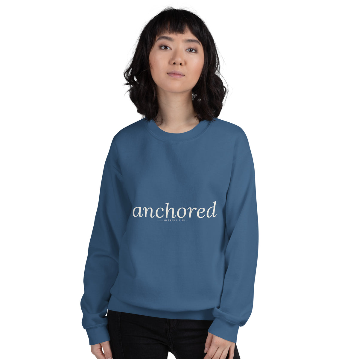 Anchored Christian unisex crewneck sweatshirt in Indigo Blue, front view on women's model