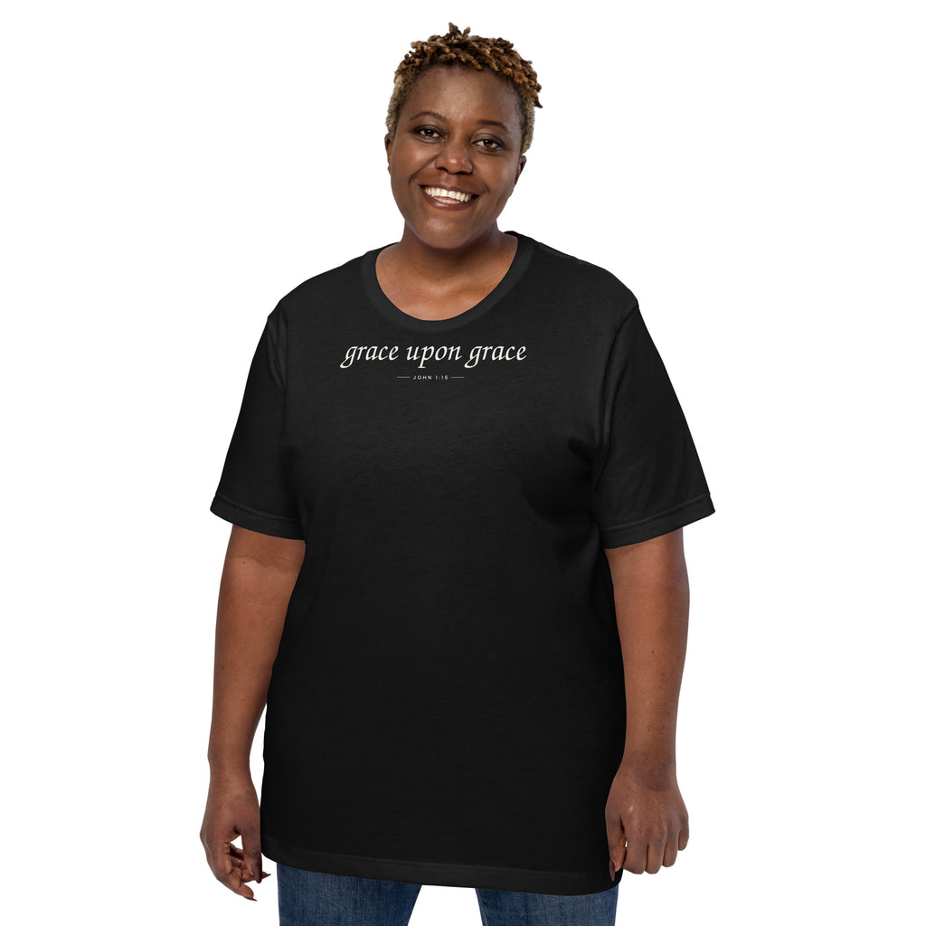 Grace Upon Grace Christian unisex tee in Black, front view on women's model